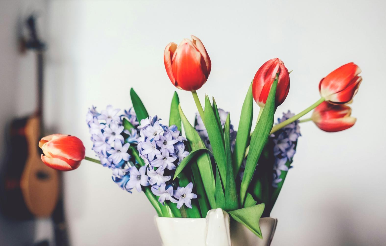 Students working on floral arrangements in bright workshop setting